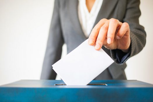 elections, The hand of woman putting her vote in the ballot box