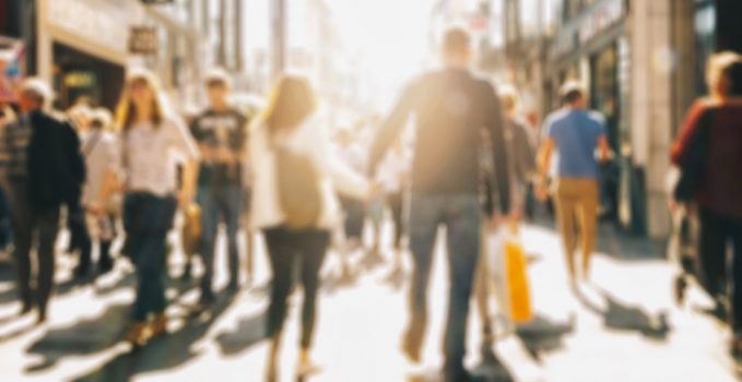 crowd of people in a shopping street, defocused background